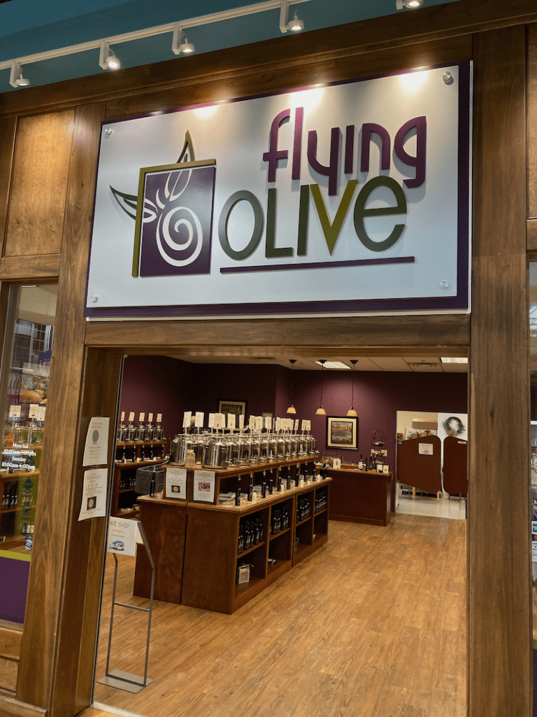 Image of the storefront entrance displaying selection of extra virgin olive oils and balsamic vinegars